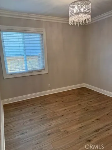 Beautiful Laminate Flooring, crown molding and beaded light fixture