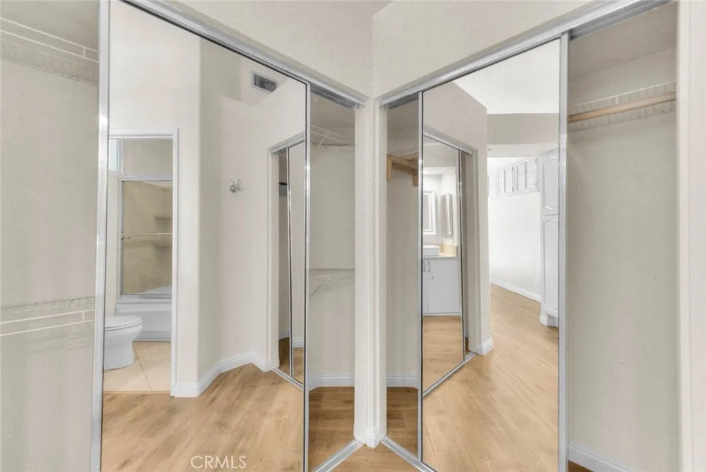 Double closets with mirrored doors in primary