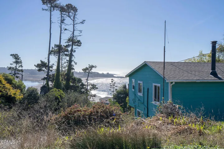 east side of house w beach view in backg