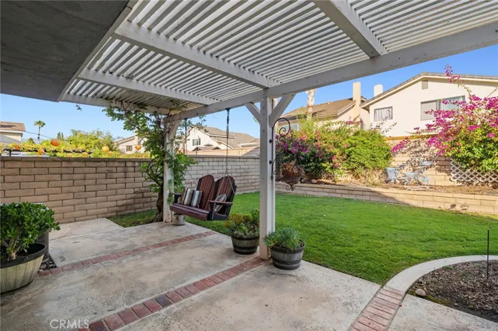 while the covered pergola with a charming porch swing invites peaceful mornings and relaxing evenings