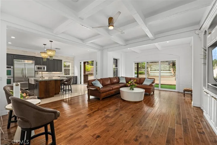 Family room offers open concept floor plan of family room, kitchen area, outdoor area beyond.