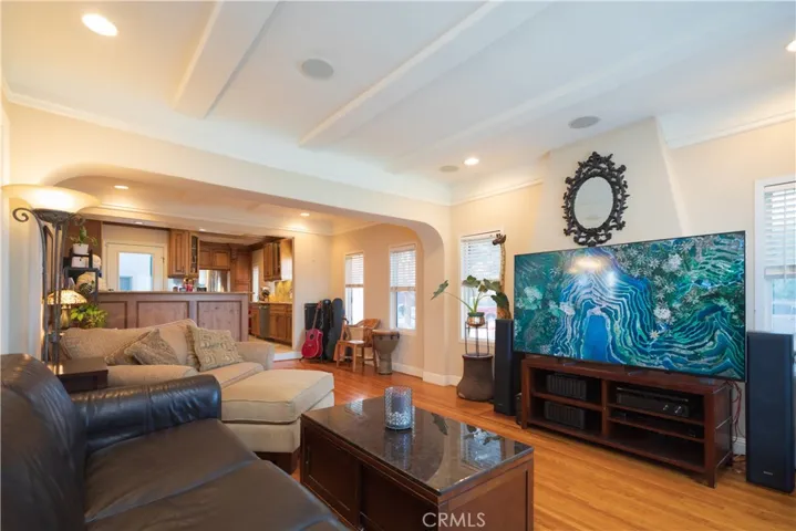 Living room offers coffered ceilings, Oak Hardwood floors recessed lighting and dual pane windows.