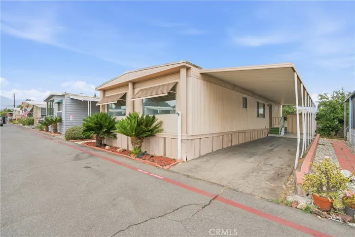 Street view of Mobile Home and Carport
