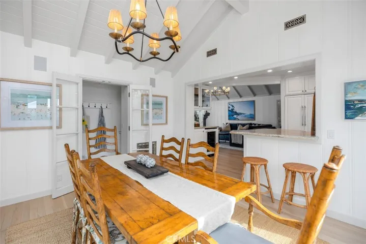 Another view of the dining room space with laundry room nearby and looking into the living room and kitchen.