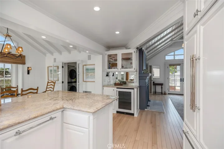 Looking out from kitchen into the living room and wet bar.