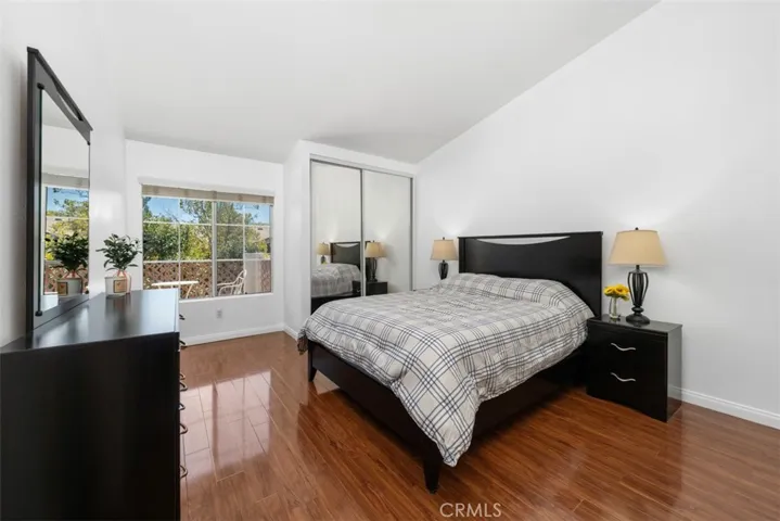 Spacious primary bedroom features just the right amount of natural light,...