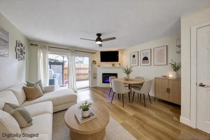 Spacious, open-plan living area with an electric fireplace, so you can enjoy the ambience without the heat on summer evenings (or have the heat as well in the winter months!). New flooring and dual-pane sliding door to large patio.