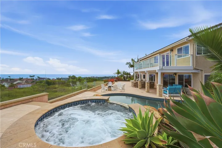 Spa and pool area offers stunning panoramic views of the Pacific Ocean and coastline, creating a spectacular setting for outdoor relaxation and entertaining.