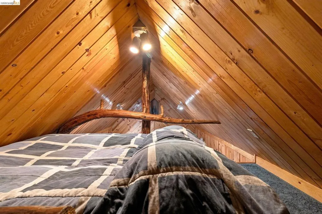 Vaulted wood-paneled ceiling with exposed beams
