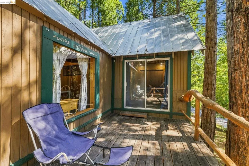 Exterior wood siding with a metal roof and an expansive wood deck