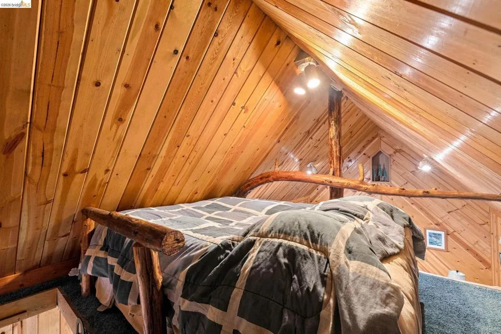 Vaulted wood-paneled ceiling with exposed wood beams