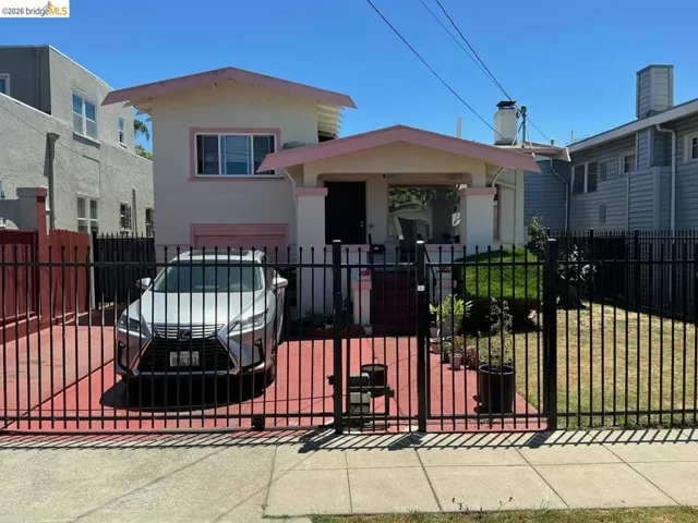 Two-story stucco residence featuring a covered front porch and a paved driveway