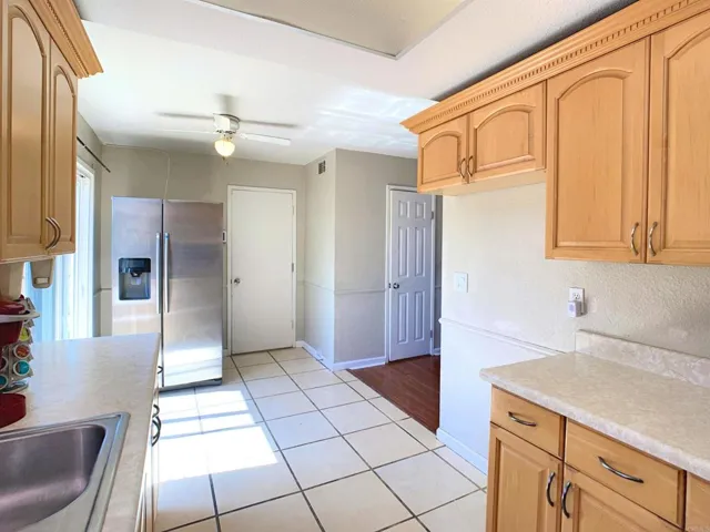 Kitchen with entrance to garage and backyard