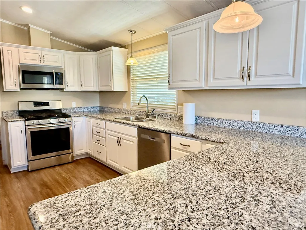 Updated kitchen with stainless steel appliances, granite counters
