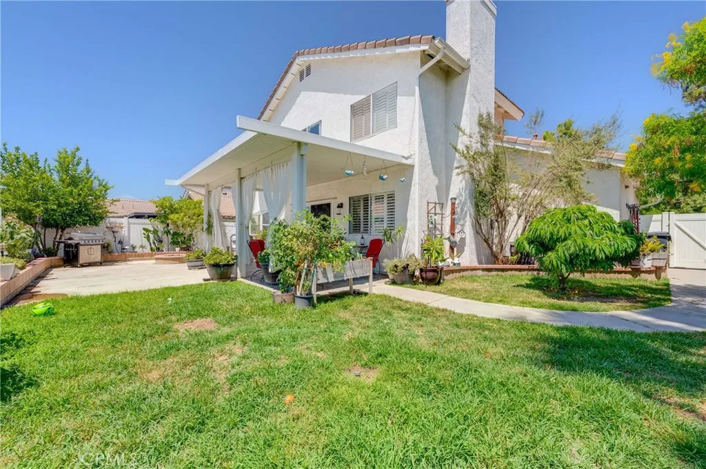 Huge Back Yard with Grass Area, Covered Patio, Side Dog Area, and Vinyl Fencing
