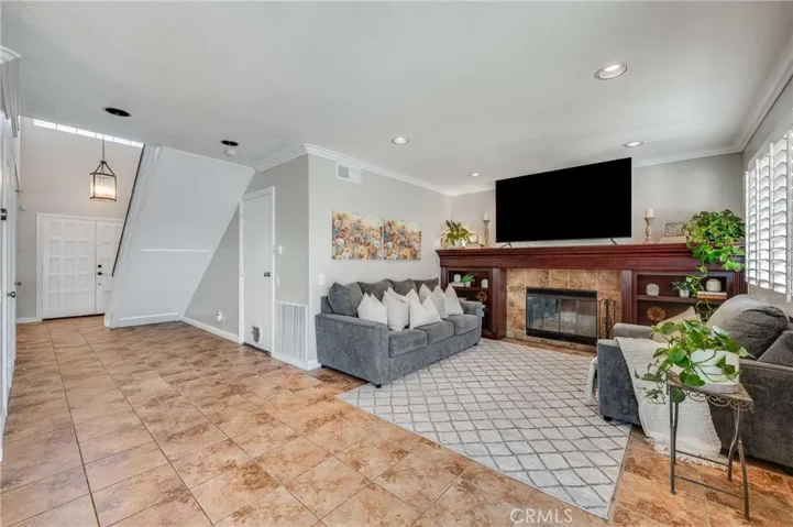 Family Room with Built-Ins, Gas Fireplace, Recessed Lighting, and Plantation Shutters