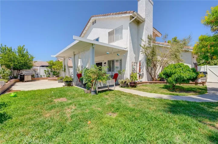 Huge Back Yard with Grass Area, Covered Patio, Side Dog Area, and Vinyl Fencing
