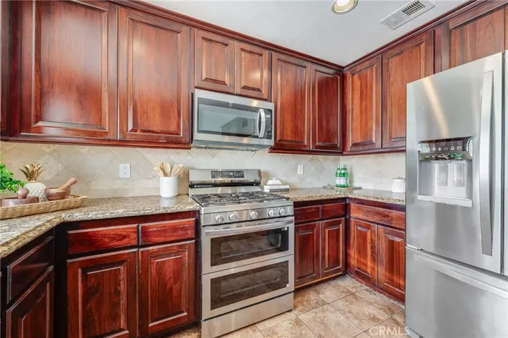 Remodeled and Updated Gorgeous Kitchen, complete with Stainless Steel Appliances, Custom Cabinets, Granite Counter Tops, and Tiled Floors