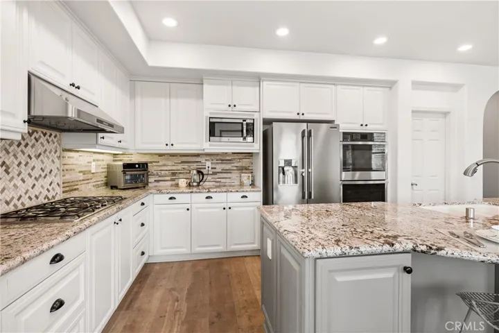 Spacious kitchen with granite countertops and stainless steel appliances
