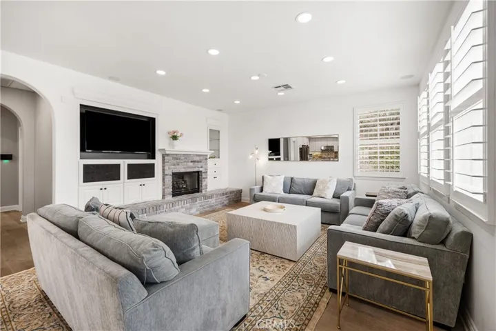 nviting family room with fireplace and built-in media center