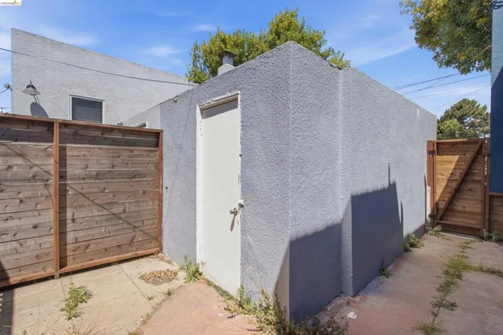 Exterior structure featuring a stucco finish and a white access door