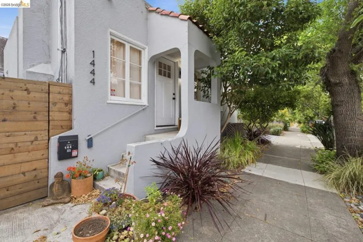 Gray stucco exterior with a tiled roof accent