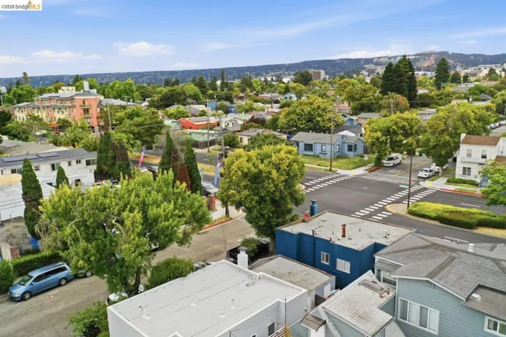 Expansive aerial perspective showcasing a residential neighborhood with varied architectural styles and mature trees