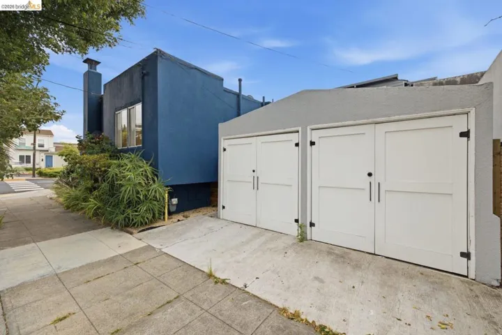 Two white garage doors with black hardware