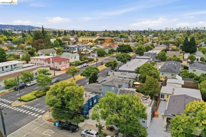 Aerial perspective showcasing a residential neighborhood with varied architectural styles and abundant mature trees