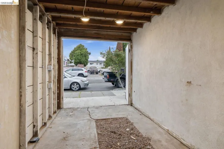 Interior space featuring exposed wood ceiling joists and concrete flooring