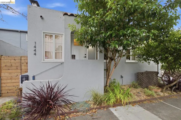 Stucco exterior with a terracotta tile roof accent