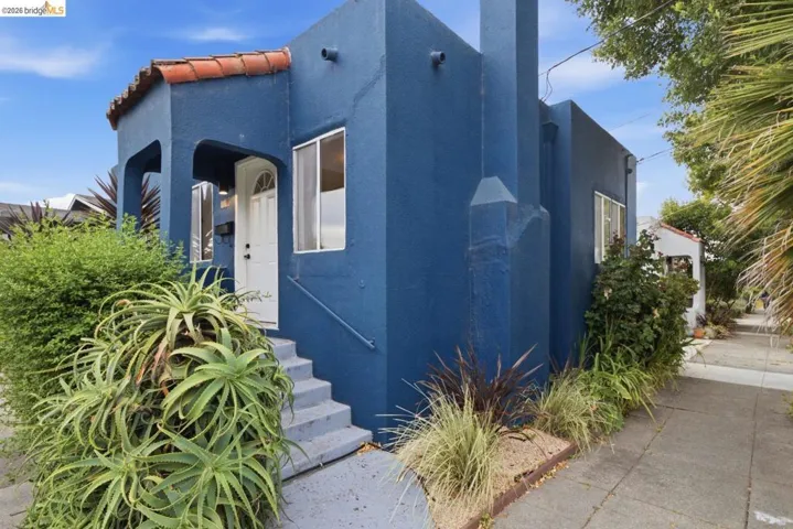 Blue stucco exterior with white-framed windows