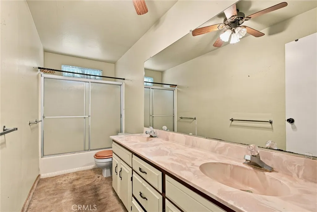 Hall bathroom has shower over tub.