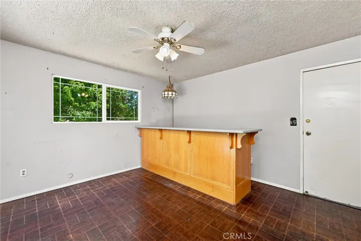 Den area with garage entry.