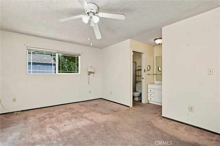 Primary bedroom has vanity area and separate wet room with shower.