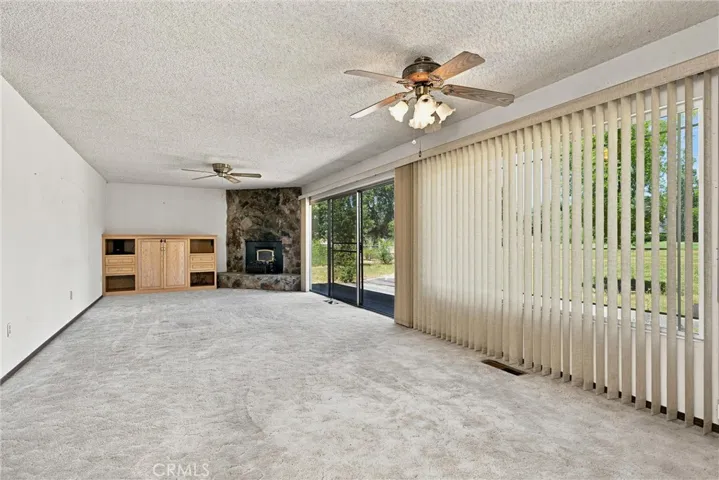 Large living and dining area is all windows looking toward the backyard.