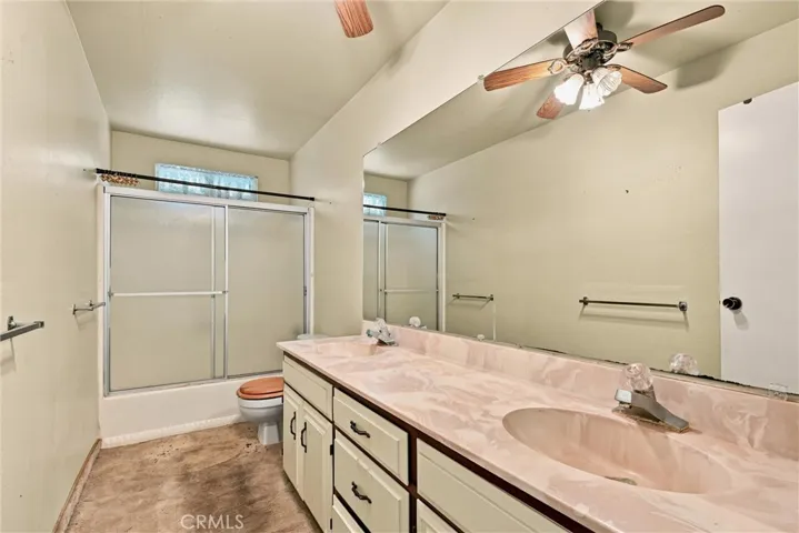 Hall bathroom has shower over tub.