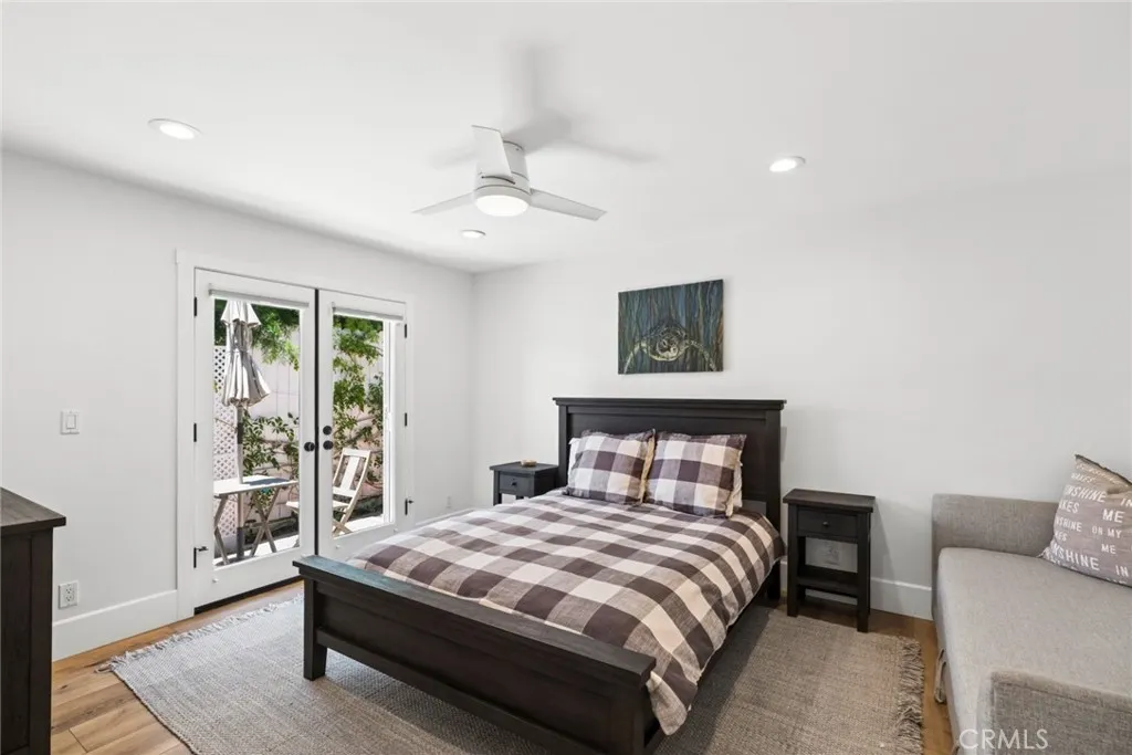  Two additional bedrooms open through French doors to a secluded patio with an above ground spa and outdoor shower, the perfect setting to unwind after a day at the beach.