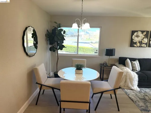 Naturally lit dining area featuring wood-finish flooring