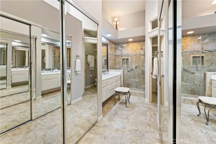 Spa-like Bath with tiled shower. Mirrored closets on Both Sides of entry.