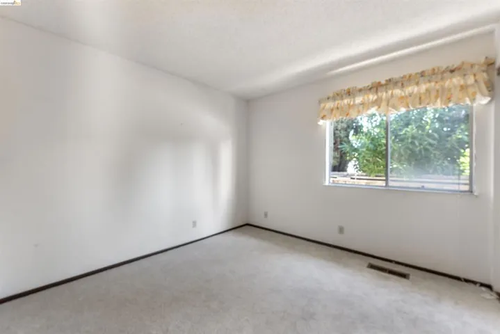 Neutral-toned carpeting paired with white walls