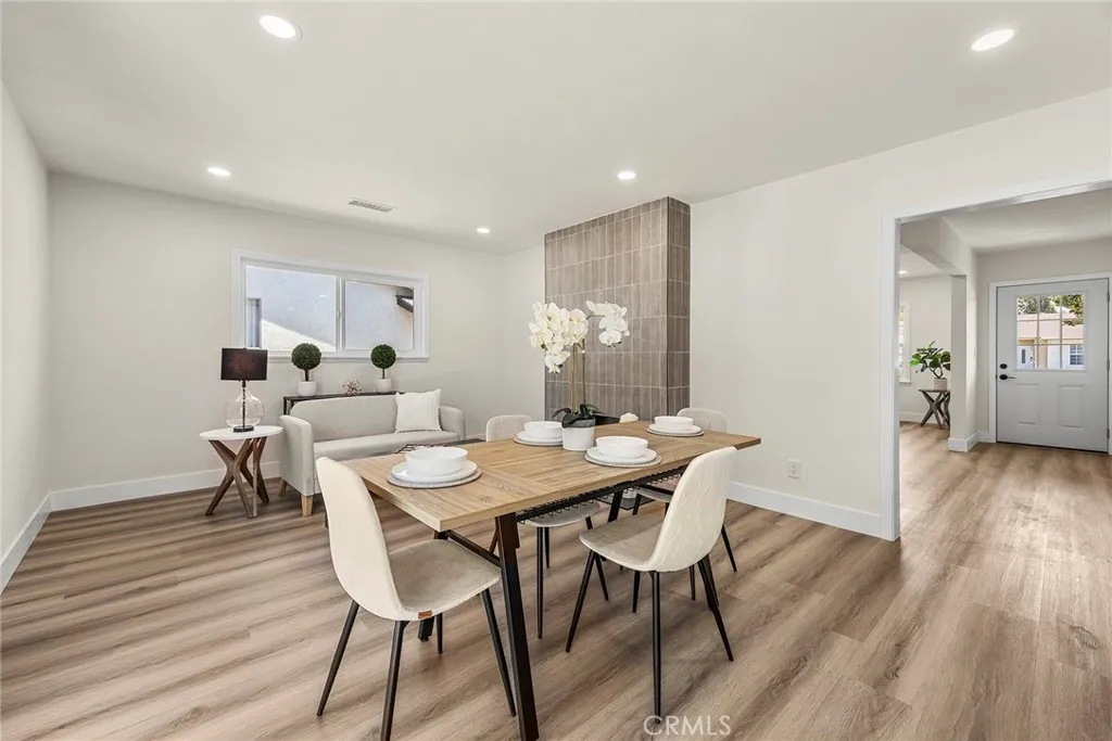 Dining area adjacent to a cozy fireplace seating nook, ideal for entertaining