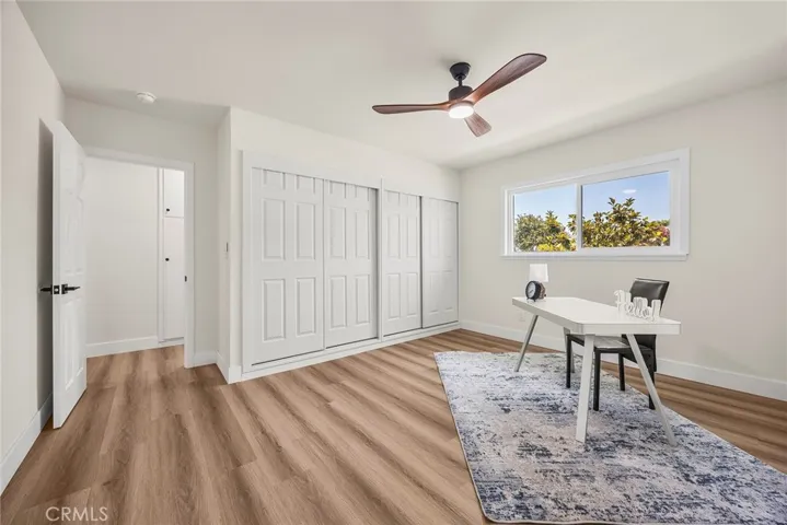 Bedroom #3 or versatile flex space with wall-length closets and ceiling fan
