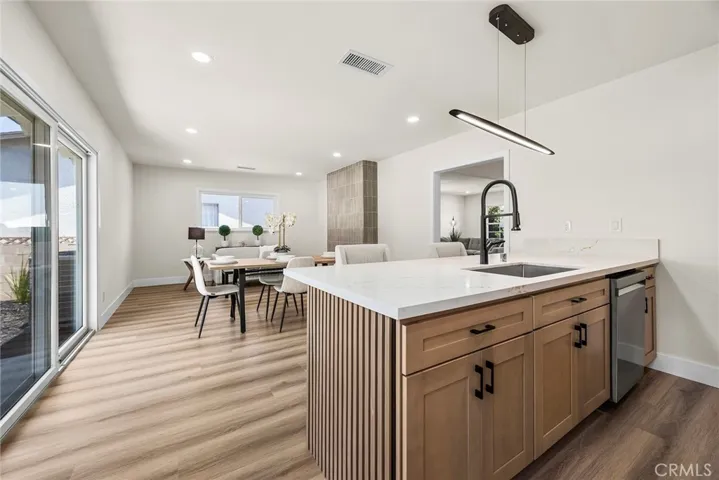 Natural wood shaker cabinetry with black hardware, quartz counters, and KitchenAid stainless steel appliances
