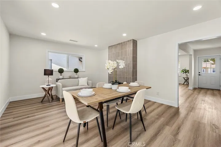Dining area adjacent to a cozy fireplace seating nook, ideal for entertaining