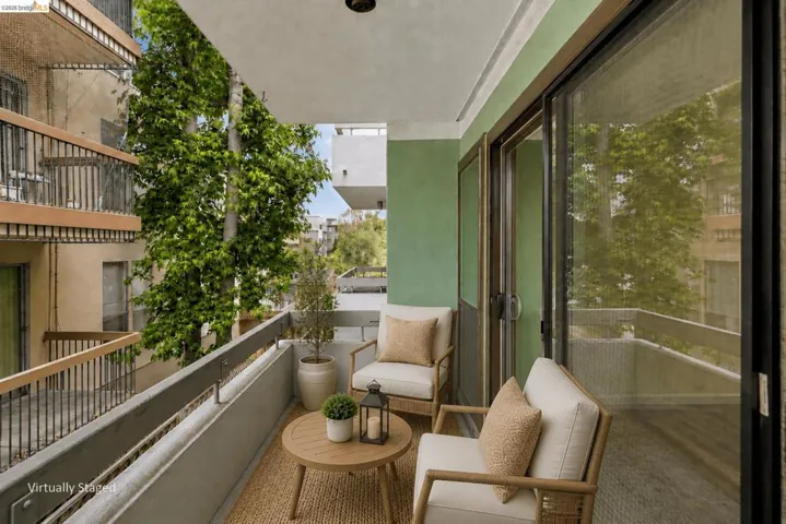 Private balcony with green-painted walls and a sliding glass door