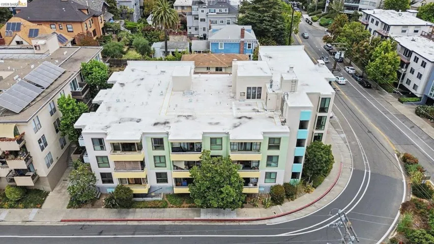 Multi-story building featuring balconies and a flat roofline