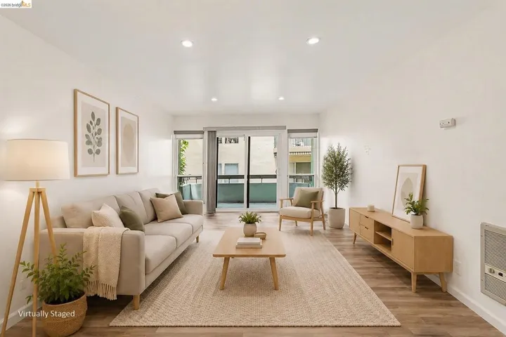 Bright living area featuring wood-finish flooring, recessed lighting, and a neutral color palette