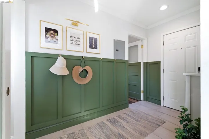 Entryway featuring green wainscoting and light wood-finish flooring