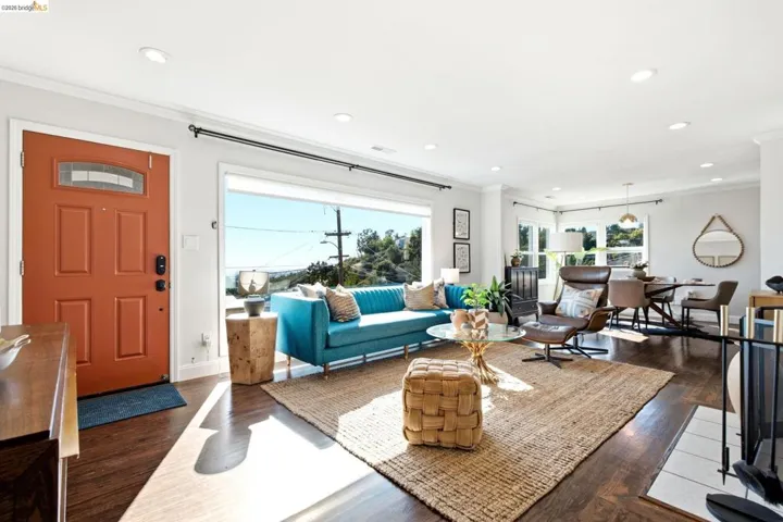 Open-concept living space featuring wood-finish flooring, recessed lighting, and expansive windows with City Views